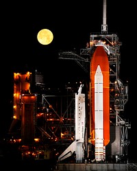 A nearly full Moon sets as the space shuttle Discovery sits atop Launch pad 39A at the Kennedy Space Center in Cape Canaveral, Florida, Wednesday, March 11, 2009. Original from NASA . Digitally enhanced by rawpixel.