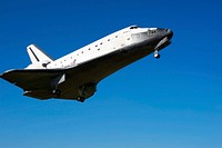 Coming in from the southeast, space shuttle Atlantis belly is visible in a crystal-clear blue sky as it approaches Runway 33 at the Shuttle Landing Facility at NASA&#39;s Kennedy Space Center in Florida. Original from NASA. Digitally enhanced by rawpixel.