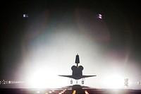 Xenon lights help lead space shuttle Endeavour home to NASA's Kennedy Space Center in Florida. Endeavour landed for the final time on the Shuttle Landing Facility's Runway 15, marking the 24th night landing of NASA's Space Shuttle Program. Original from NASA. Digitally enhanced by rawpixel.