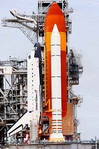 Space shuttle Atlantis, attached to its bright-orange external fuel tank and twin solid rocket boosters on Launch Pad 39A at NASA&#39;s Kennedy Space Center in Florida. Original from NASA. Digitally enhanced by rawpixel.
