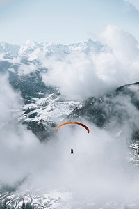 Paragliding on a cloudy day through the mountain