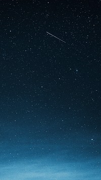 Shooting star in the dark blue sky over Greenland