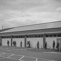People lining up outside the supermarket with social distancing during coronavirus pandemic. BRISTOL, UK, March 30, 2020