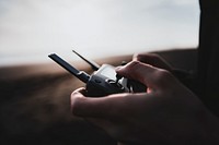 Man controlling a drone by a remote control