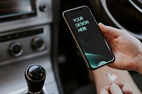 Blank smartphone screen mockup charging in a car