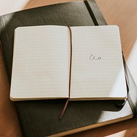 Blank notebook page on wooden desk mockup
