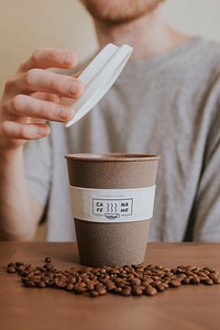 Man opening a reusable coffee cup mockup