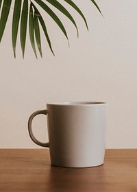 Earth tone color ceramic coffee cup on wooden table