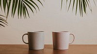 Earth tone color ceramic coffee cups on wooden table