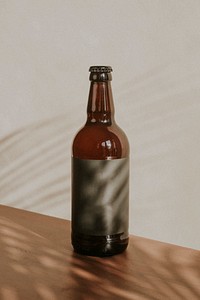 Brown beer bottle on wooden background