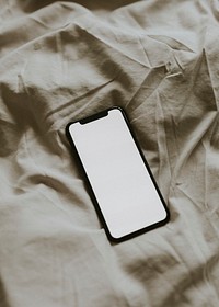 Blank screen smartphone on  fabric textured background