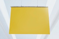 Yellow poster sign mockup psd hanging from a ceiling