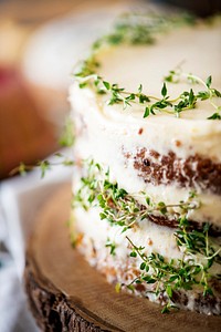 Buttercream cake decorated with thyme