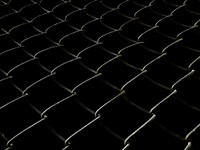 Welded mesh fence at night