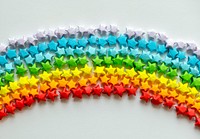 Colorful origami stars forming a rainbow background