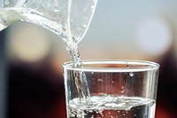 Macro shot of pouring water into a glass