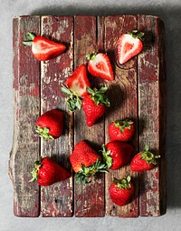 Freshly cut strawberries on a wooden board