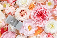 Wedding ring on pastel flower patterned background