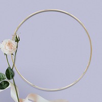 Round gold frame with white roses on purple background