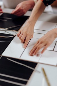 Designer cutting a pattern in a paper
