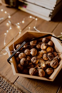 Walnuts in a wooden basket on a wooden floor