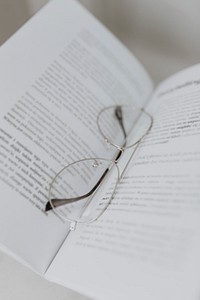 Eyeglasses on an open textbook