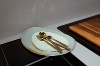 Brass cutlery on a ceramic dish