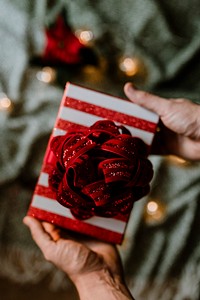 Hands holding a Christmas themed gift