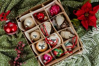 A box of Christmas ornaments on a green cloth