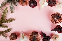 Paper ball garlands and pine branches on pink background