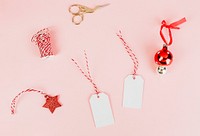 Christmas gift tags and bauble on peach background