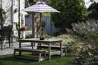 Wooden table set in a patio with a parasol