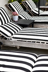 Wooden seats with black and white striped cushions