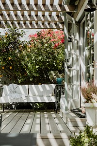 Outdoor wooden couch with white cushions