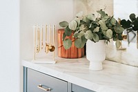 Clean kitchen with golden utensils on the countertop