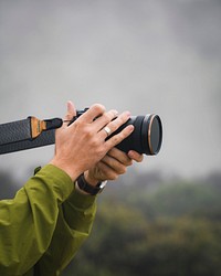 Man taking photos in a misty forest
