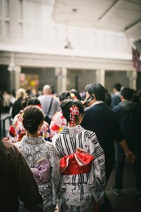 Rear view of Japanese women in yukata among the crowd