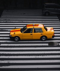 Yellow taxi on a crosswalk in Japan