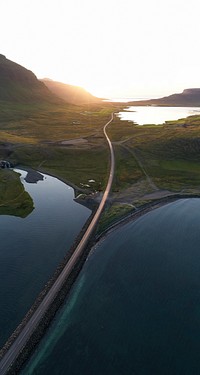 Road along the lake in the morning drone shot
