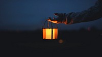 Desktop wallpaper background, hand holding a lantern in the dark