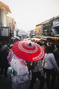 Woman in yukata walking on a crowded street