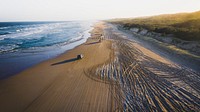 Landscape desktop wallpaper background, cars driving on a beach