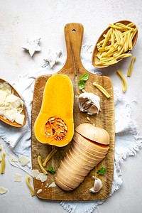 Slices of butter squash on a wooden cutting board