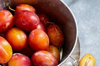 Fresh ripe plums in a pot
