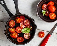 Sliced tomatoes cooking in a skillet