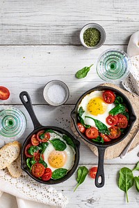 Freshly cooked eggs and tomatoes in a skillet