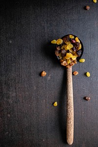 Raisins in a wooden spoon