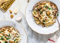 Serving of homemade pappardelle pasta with mushrooms and parmesan cheese