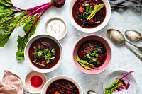 Bowls of healthy beetroot leaf soup with cream on a table food photography