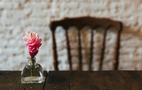 Red ginger flower on a wooden table